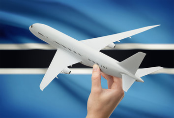 Airplane in hand with flag on background - Botswana