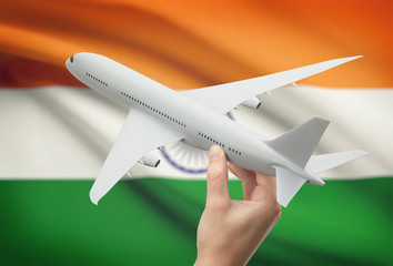 Airplane in hand with flag on background - India