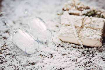 Christmas background with wineglasses and present on snow 
