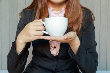 Woman drinking tea or coffee in cafe