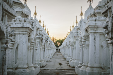 White stupas at Kuthodaw Pagoda at Sunset in Mandalay, Myanmar