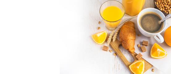Croissants, coffee and orange juice, top view. Breakfast concept
