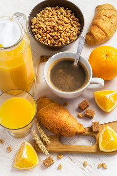 Breakfast concept - coffee, croissant and orange juice on a whit