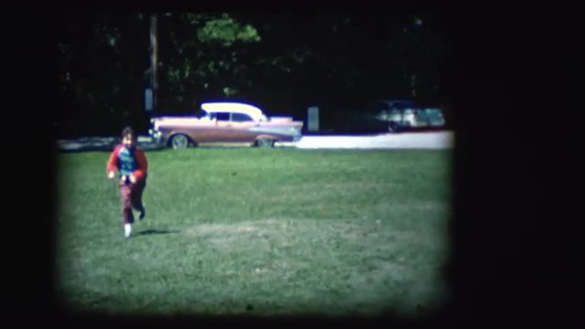 Vintage 8mm footage of a girl in a park with a 1957 Chevy in the background