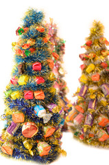 Artificial Christmas trees decorated with delicious sweets.