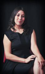 Model in black seated.