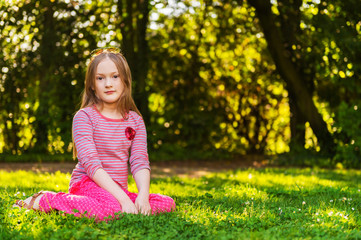 portrait of a cute little girl of 7 years old in the park