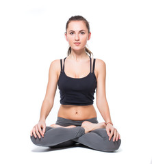 Attractive fit woman exercising in studio with copyspace. Image of healthy young female athlete doing fitness workout against grey background.