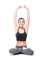 Obraz premium Attractive fit woman exercising in studio with copyspace. Image of healthy young female athlete doing fitness workout against grey background.