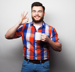 young bearded man with a cup of coffee