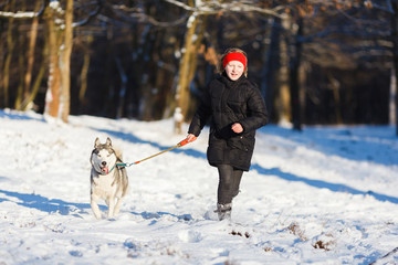 Teenage girl with a husky dog