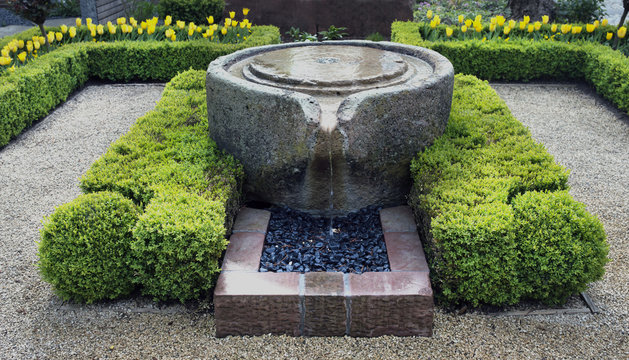 Beautiful stone fountain surrounded by box trees, Baden Baden, Germany