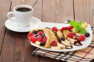 Crepes With Berries and cup of coffee. 