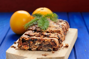 Vegan fruit cake with oranges and glass jar decorated with fir t