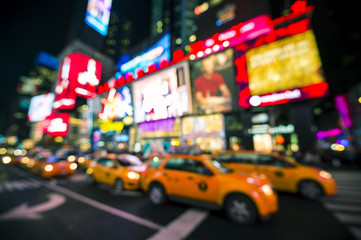 Defocus view of Times Square signage, traffic, and holiday crowds in the lead-up to New Year's Eve...