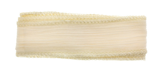 Ivory ribbon cloth material on a white background