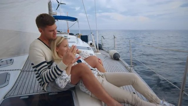 Young couple having romantic time on a yacht in the sea. Shot on RED Cinema Camera.