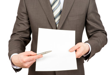 Businessman pointing at blank paper with pen 