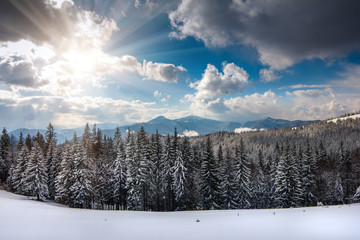 Panoramic views of the snow-capped mountain peaks on a sunny winter day.