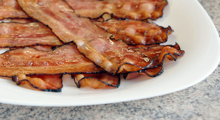Fried bacon - delicious plate of sliced bacon