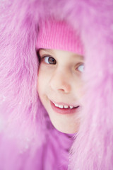 Smiling girl looking from under the hood