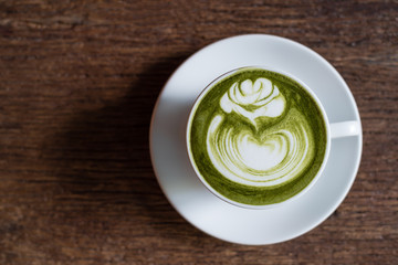 matcha green tea latte on wooden background