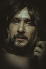 jesus christ with long hair in the foreground, a man of deep loo