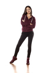 young woman in a track suit pants posing on white background