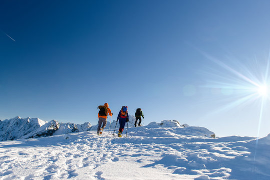 Group hikers in winter mountains, beautiful landscape and blue s
