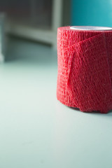 Fototapeta premium Red roll of medical adhesive tape