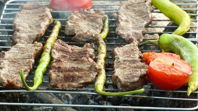  Beefsteak - steak -  green pepper and tomato cooking on the grill over coals 