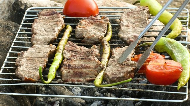  Beefsteak - steak -  green pepper and tomato cooking on the grill over coals 