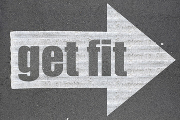 Arrow on asphalt road written word get fit