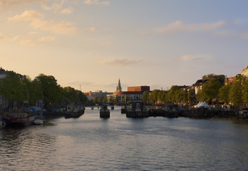Fototapeta na wymiar Amsterdam. View of the city through Amstelsluice at sunset. Netherlands.