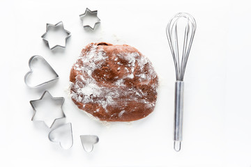 dough for chocolate cookies  and cookie cutters in the shape of