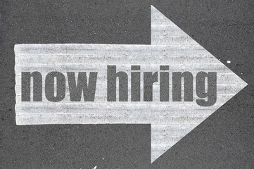 Arrow on asphalt road written word now hiring - 98921658