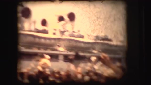 Vintage 8mm footage of a bon voyage party of a big ship setting sail