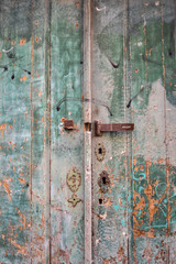 Old wood green doors closed with fade paint
