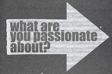 Arrow on asphalt road written word what are you passionate about