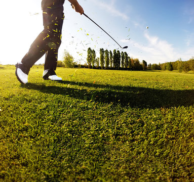 Golf swing on the course. Golfer performs a golf shot