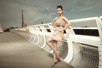 Pretty girl posing on city bridge