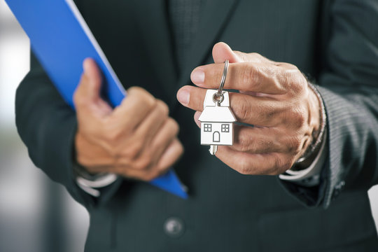 Hand with a house key 