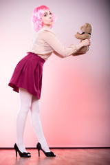 childlike woman with teddy bear toy