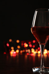 Wine glass with bokeh on dark background