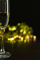 A glass of champagne with bokeh on dark background
