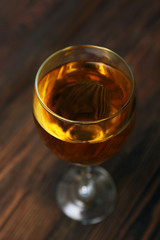 Glass of wine on wooden table. Top view