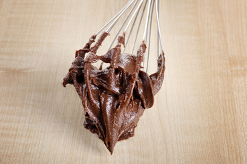 Corolla with chocolate cream on wooden background