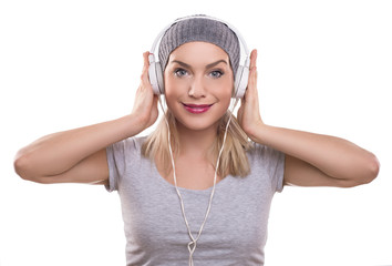 Young woman with headphones listening music, isolated on white