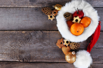 Fototapeta premium Santa hat filled with Christmas gifts, close-up