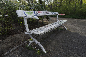 Graffiti on white wooden park bench